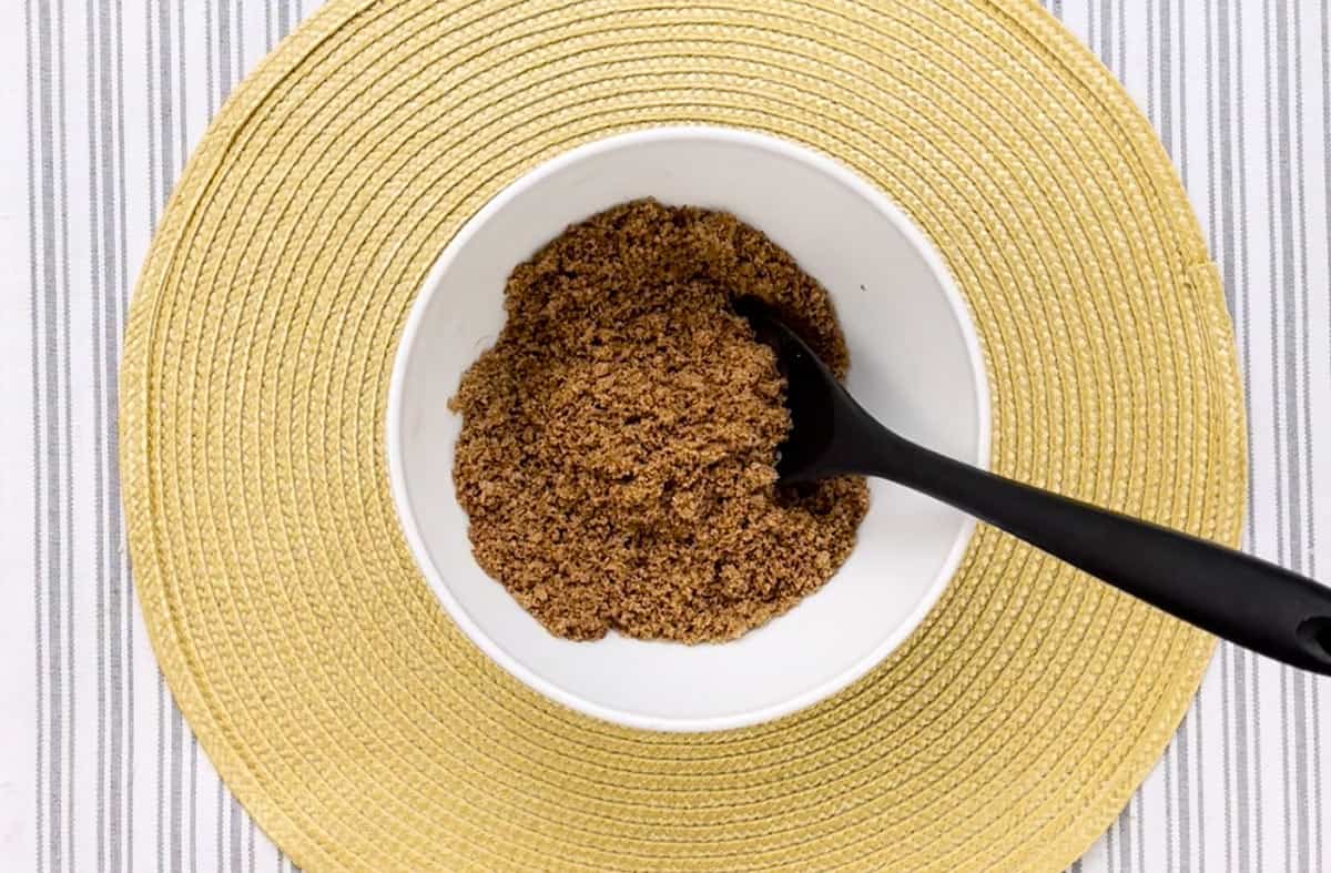 A white bowl filled with a brown sugar mixture.