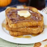 Slices of pumpkin French toast on a white plate.