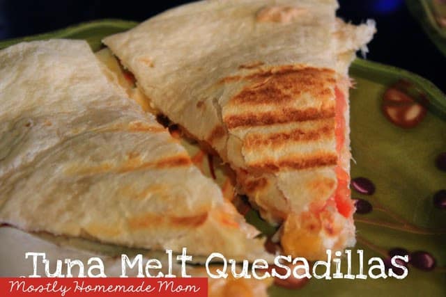Tuna melt quesadilla being served on a green plate.
