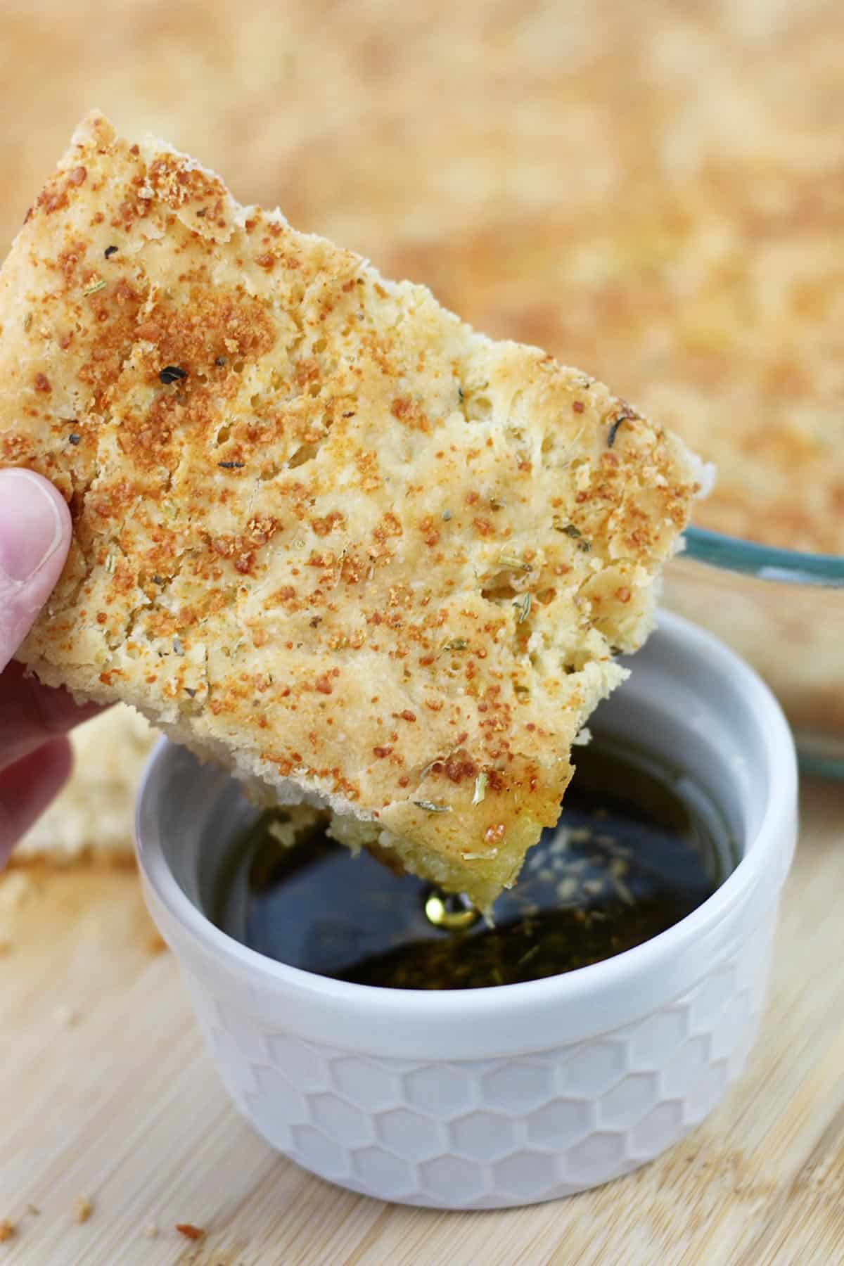 Dipping a slice of focaccia in oil.