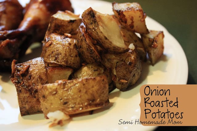 Onion roasted potatoes on a white plate.