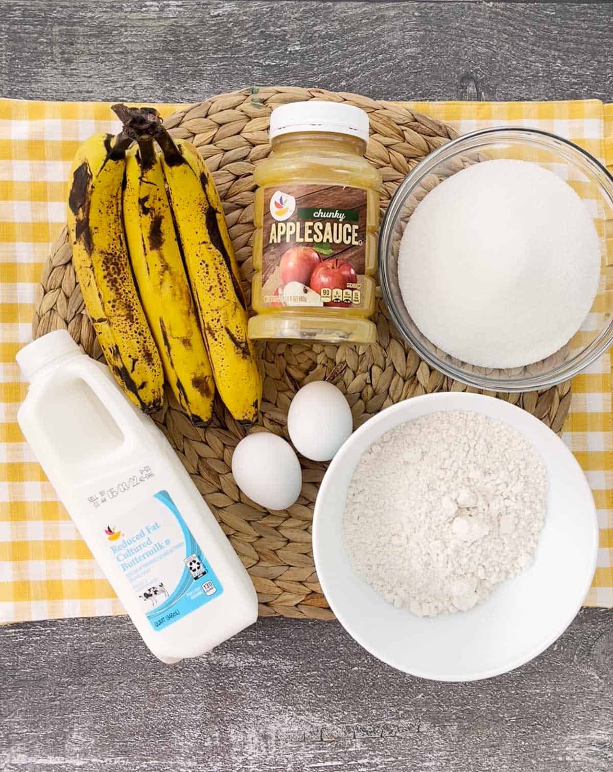 Ingredients for buttermilk banana bread on a yellow placemat.
