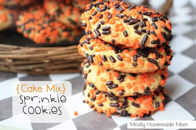 Cake mix cookies with Halloween sprinkles stacked on a placemat.