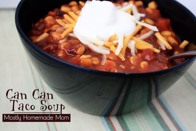 5 can taco soup in a black bowl with sour cream.