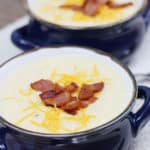 Two bowls of crockpot baked potato soup with bacon and cheese
