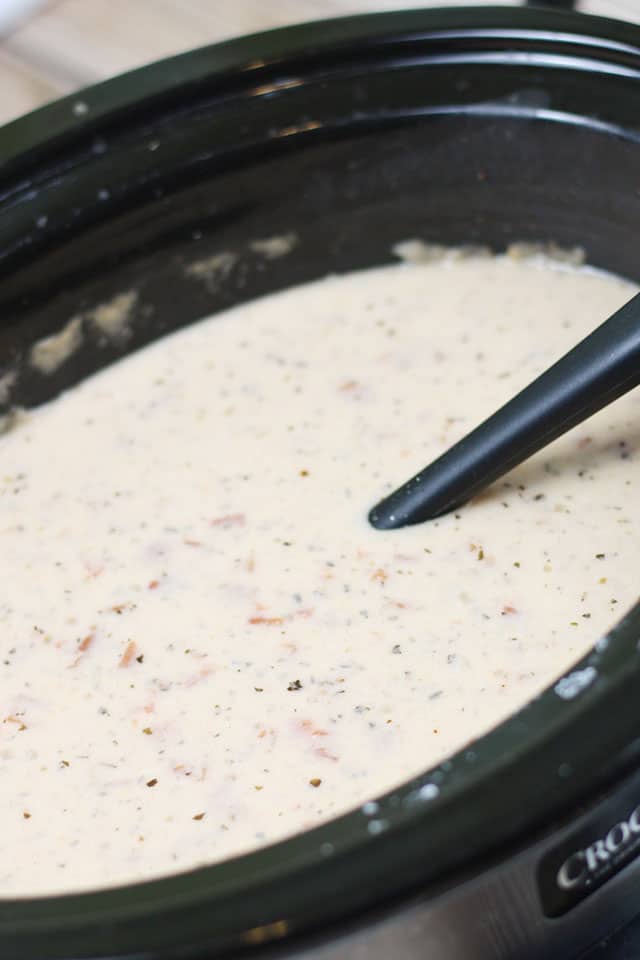 Tomato Basil Parmesan Soup in a crockpot with a ladle