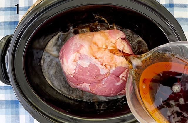 Pouring root beer over the pork roast in a Crockpot