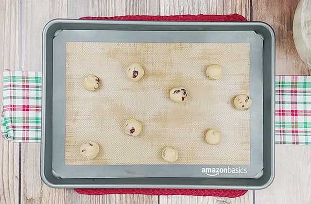 Cranberry orange cookies on a cookie sheet ready to be baked