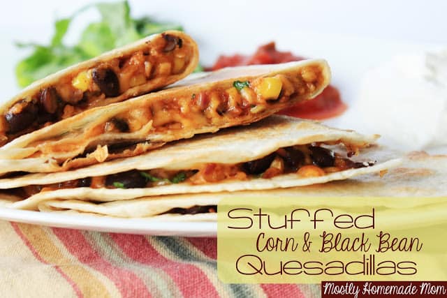Corn and black bean quesadillas slices on a white plate.