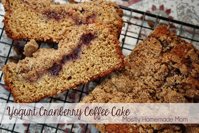 Cranberry coffee cake loaf on a black wire cooling rack.