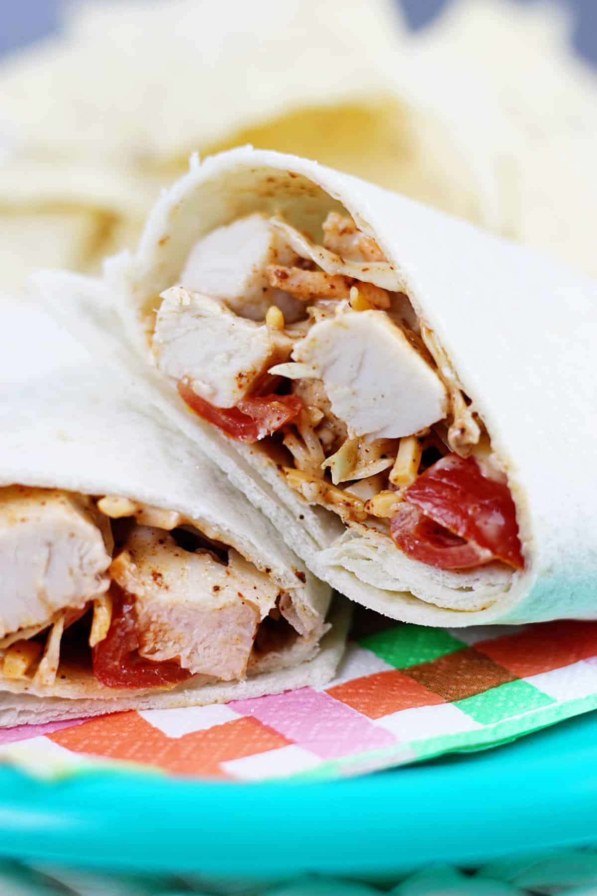 Sliced Southwest chicken wrap on a plate with a napkin.