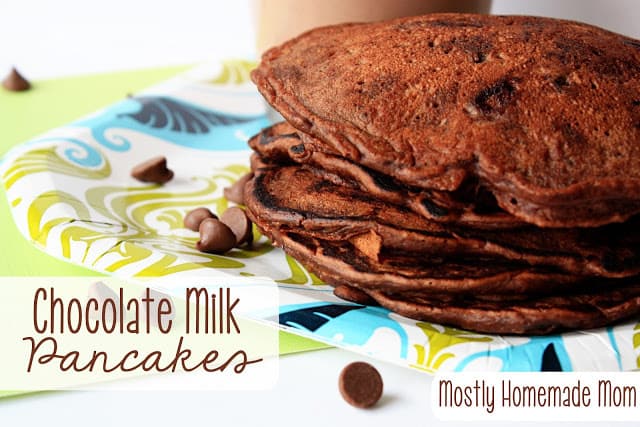 A stack of chocolate milk pancakes on a paper plate.