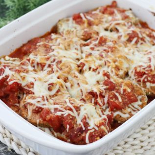 Baked Eggplant Parmesan in a white baking dish.