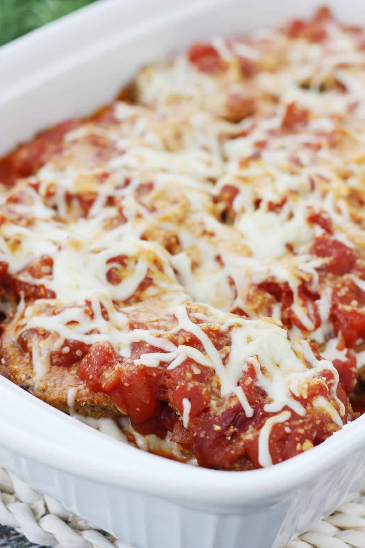 Baked eggplant Parmesan in a white baking dish. 