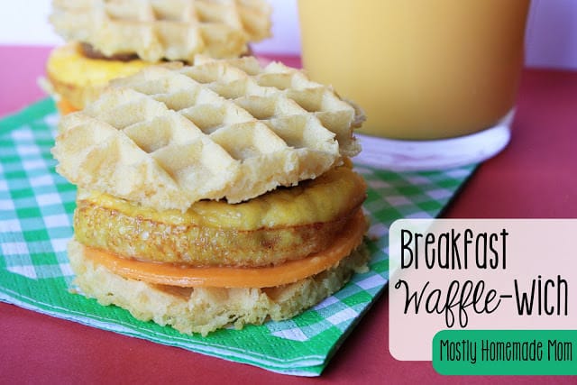 A waffle breakfast sandwich on a green plaid napkin.