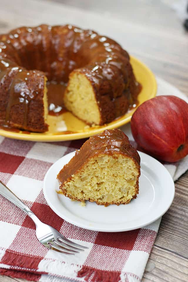Cake Mix Caramel Apple Cake on a serving plate with a slice in front