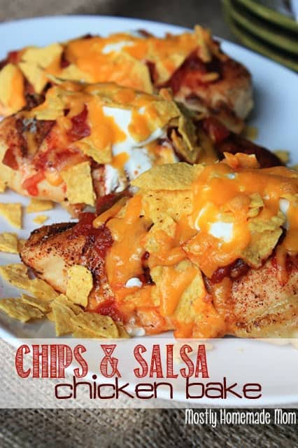 Baked salsa chicken on a white platter topped with sour cream and cheese.