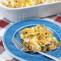 Ranch chicken enchilada casserole on a blue plate with a fork