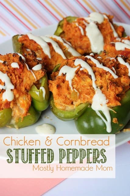 Chicken stuffed peppers with a spicy ranch drizzle on a plate.