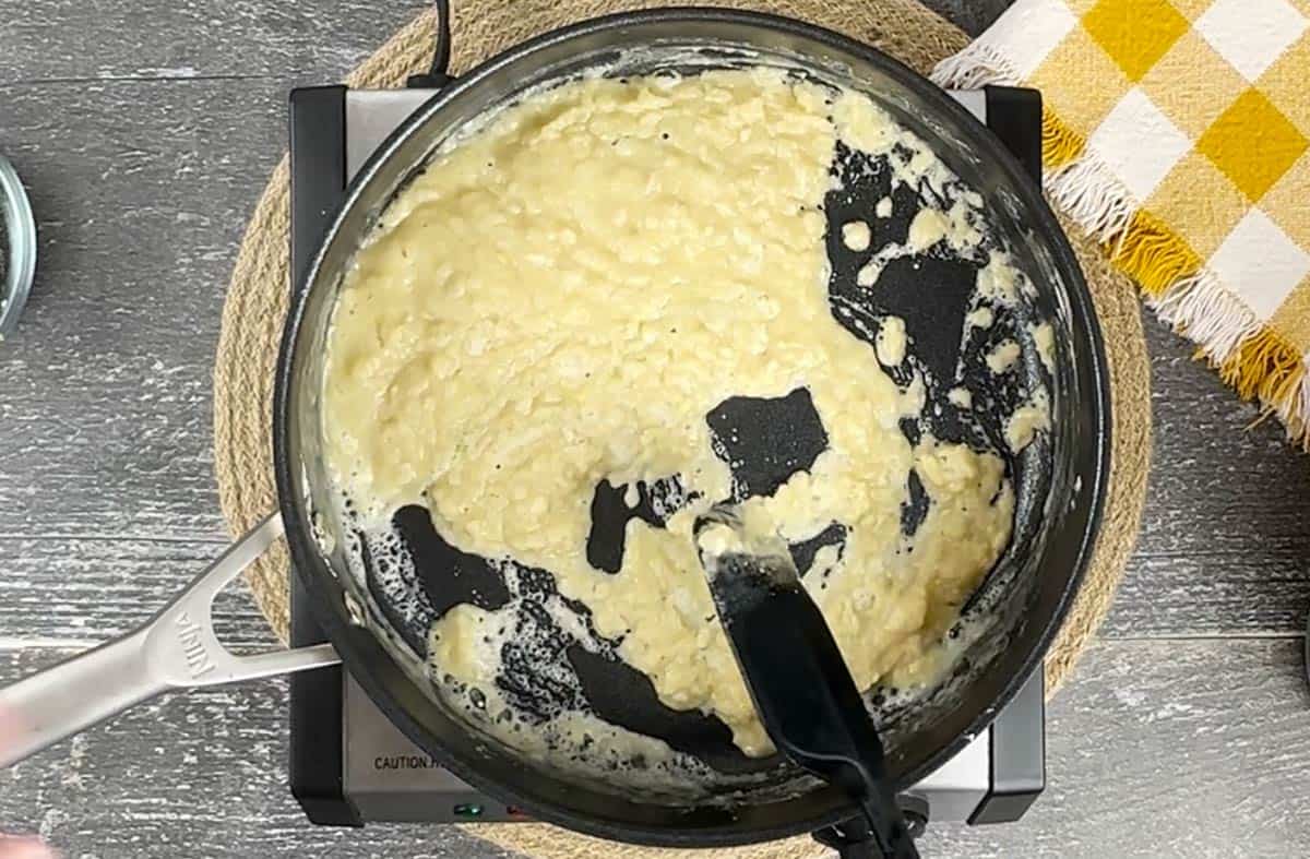Mixing a roux in a skillet.
