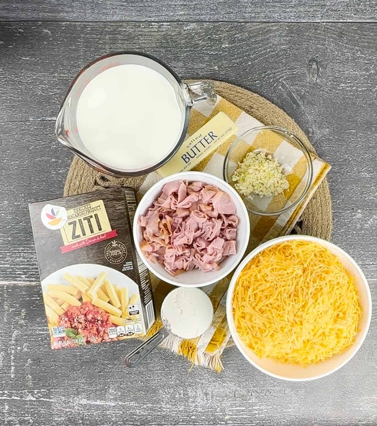 Ingredients for ham and cheese casserole on a placemat.