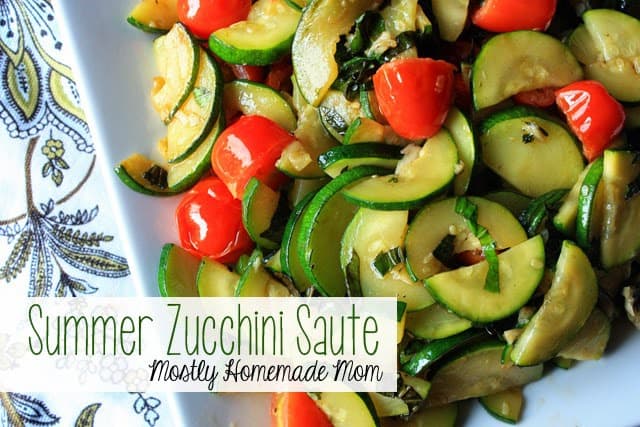 Zucchini saute with cherry tomatoes on a white plate.