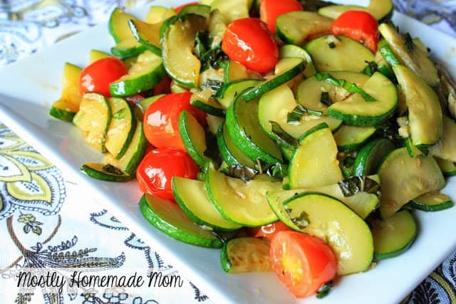 A plate of zucchini saute with tomatoes and basil.