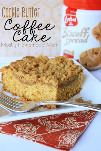 A slice of coffee cake on a plate with a fork.
