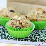 Whole wheat banana muffins in front of a lunch bag.