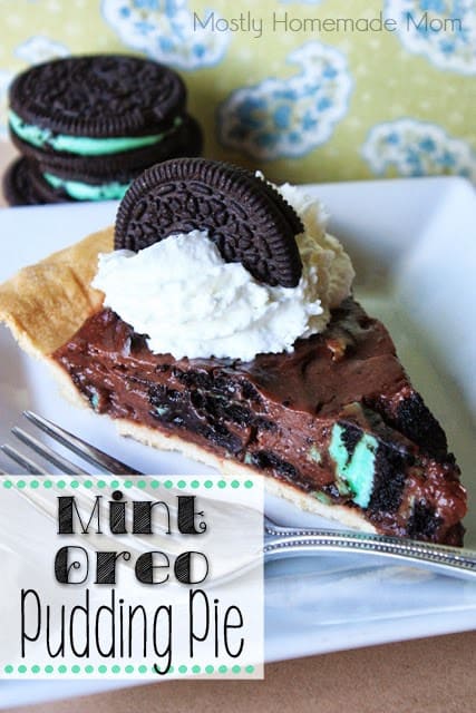 Mint oreo pie slice on a white plate with a fork.