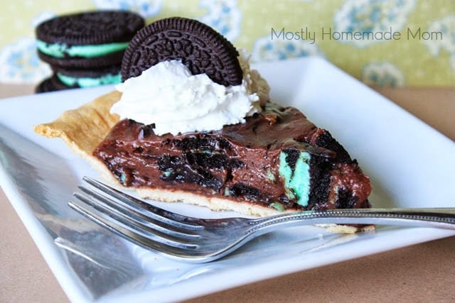A slice of mint oreo pie on a white plate.