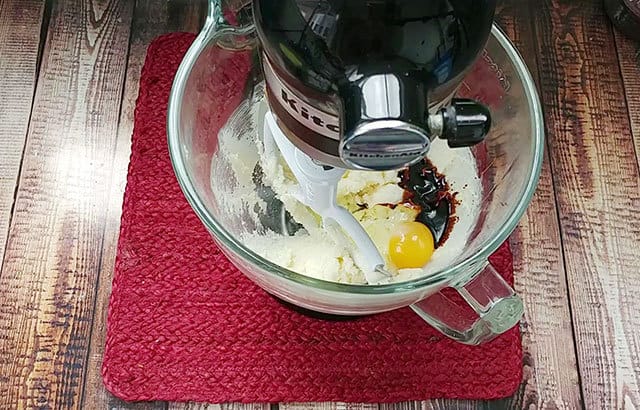 Mixing butter, sugar, egg, and molasses in a stand mixer