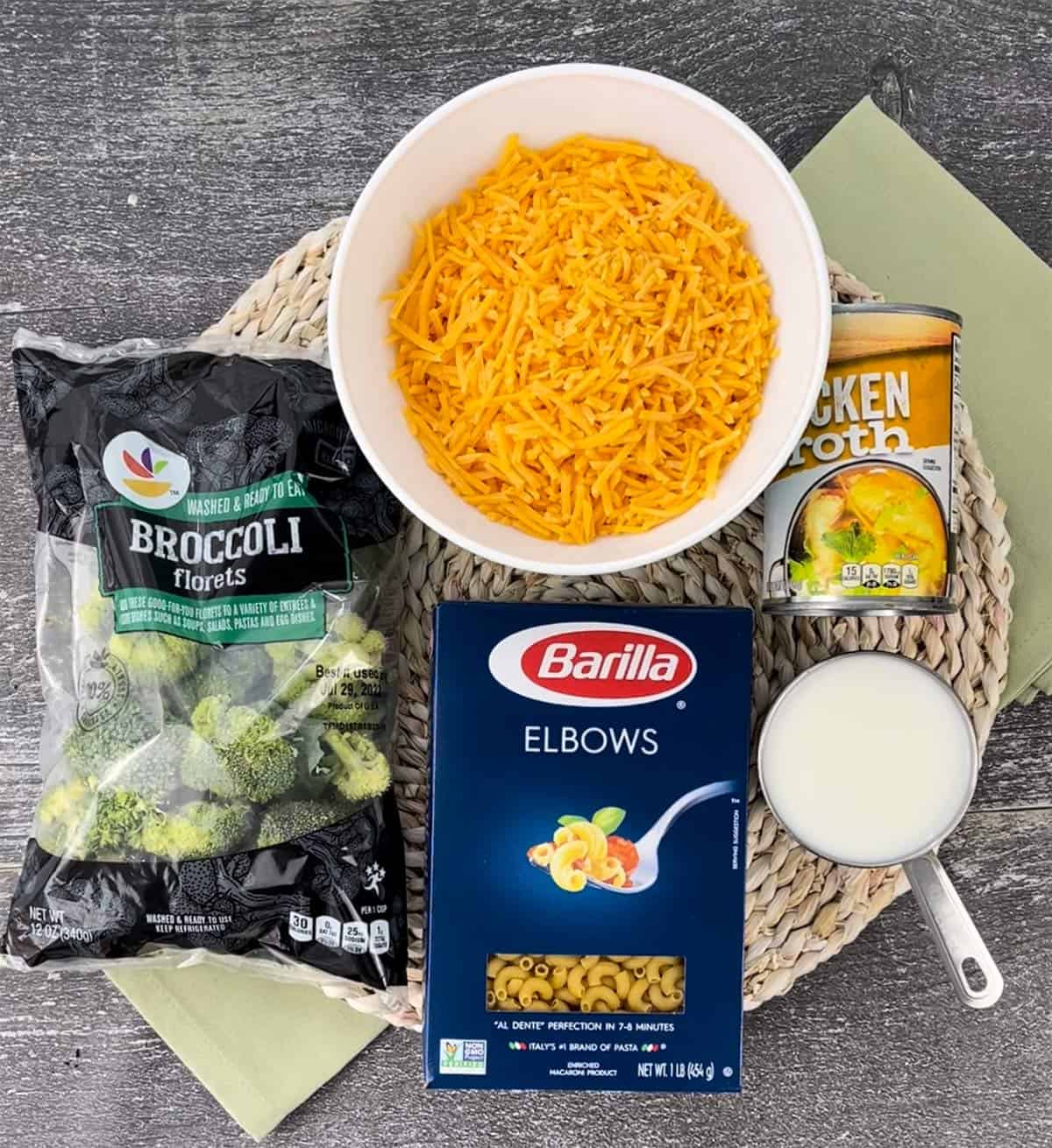 Ingredients for broccoli mac and cheese on a placemat.