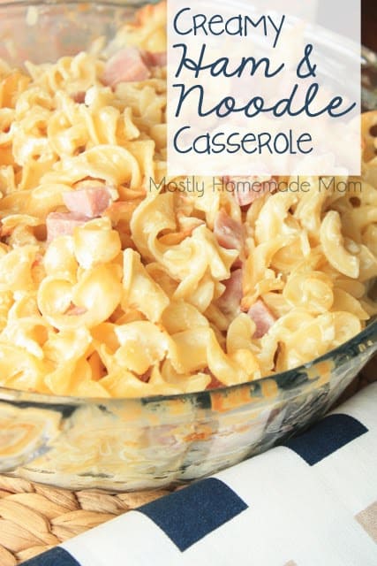 Ham and noodle casserole in a glass baking dish on a straw placemat