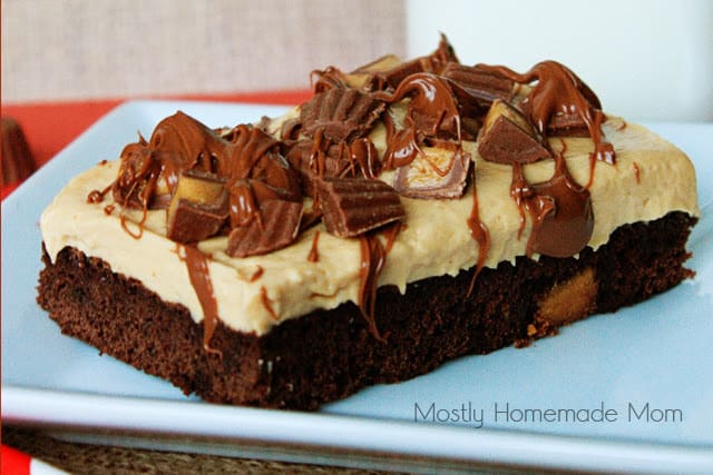 A peanut butter mousse brownie drizzled with chocolate on top on a square plate