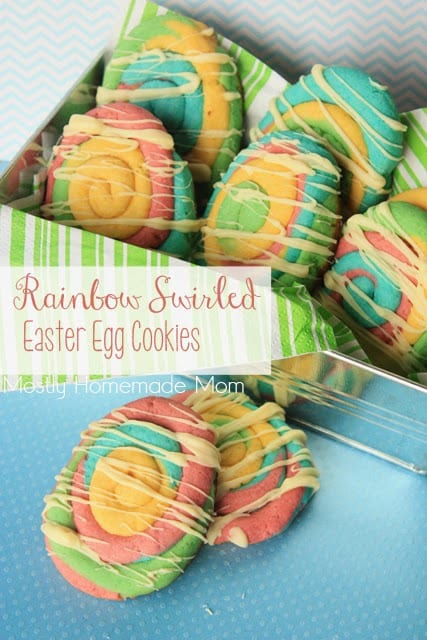 Colorful Easter egg cookies with an icing drizzle on a blue placemat