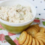 Shrimp Dip in a bowl next to crackers and a spreading knife