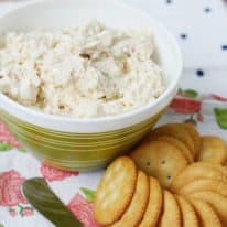 Shrimp Dip in a bowl next to crackers and a spreading knife