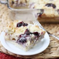 A slice of blueberry cobbler sugar cookie squares on a white plate