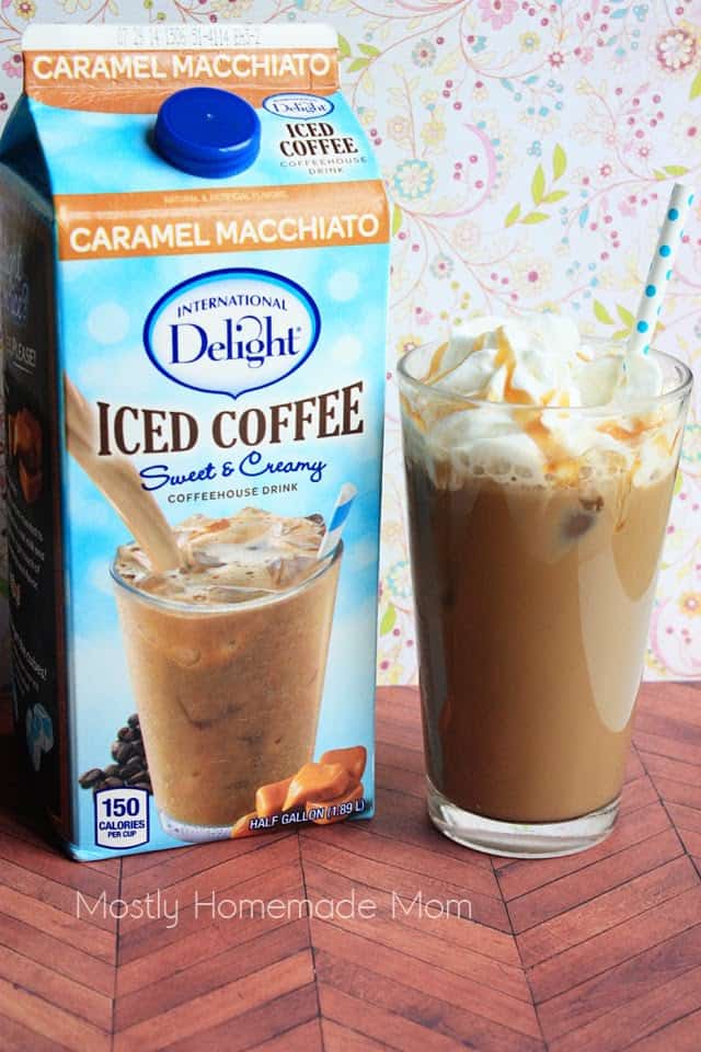 A carton of International Delight iced coffee next to a glass of iced coffee