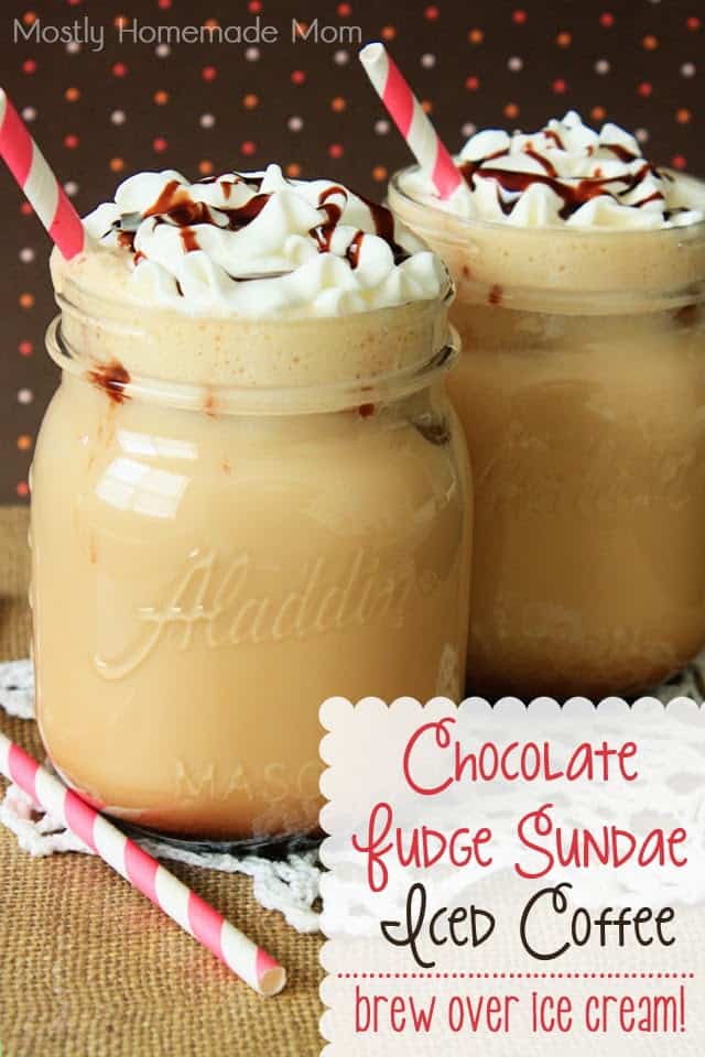 Chocolate iced coffee in glass jars topped with whipped cream and chocolate syrup