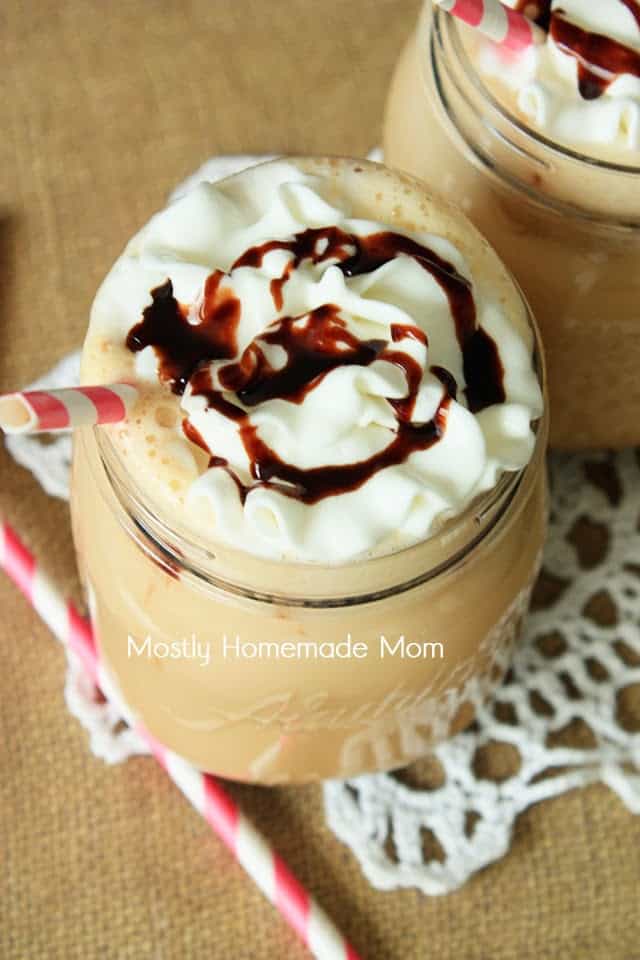 Overhead picture of a glass jar of chocolate iced coffee with whipped cream and a straw
