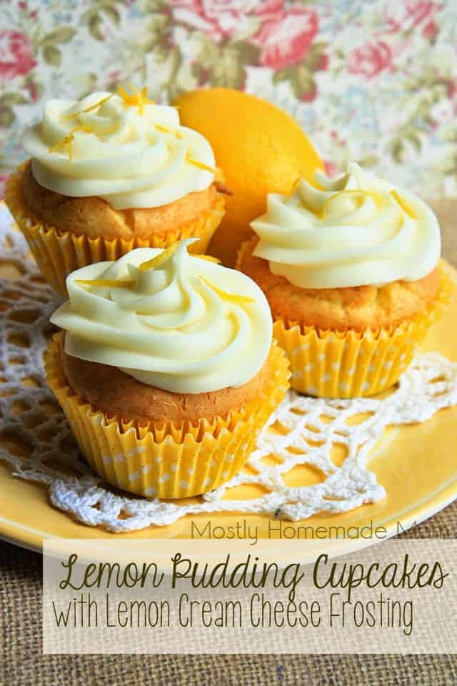 Three lemon pudding cupcakes with frosting on a yellow plate