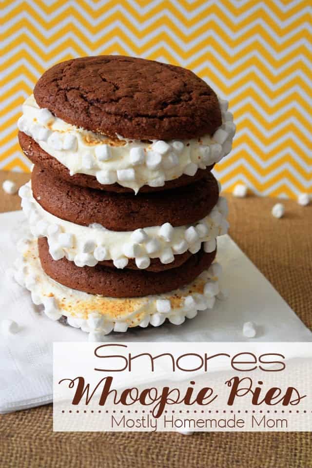 A stack of three s'mores whoopie pies on a white napkin