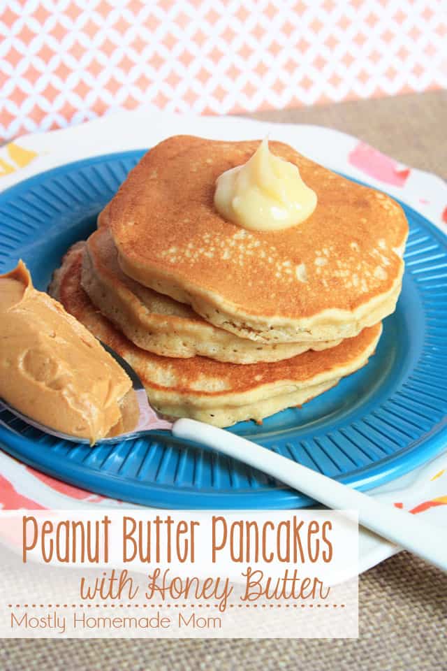A blue plate with peanut butter pancakes and a spoon of peanut butter