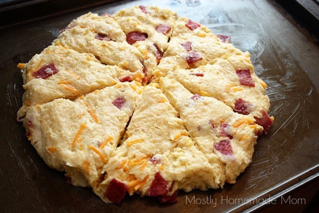 Bacon cheddar scones batter on a cookie sheet ready to be baked in the oven