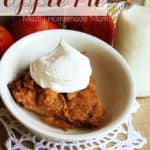 A slice of crock pot apple pie in a bowl with whipped cream