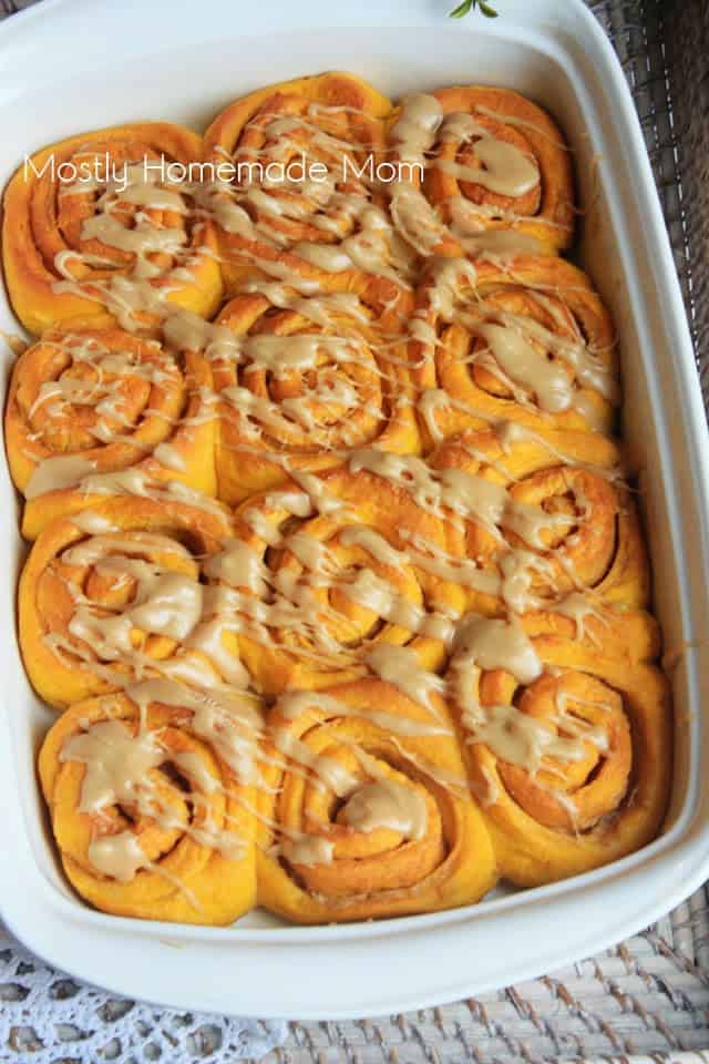 Pumpkin cinnamon rolls in a white long baking dish