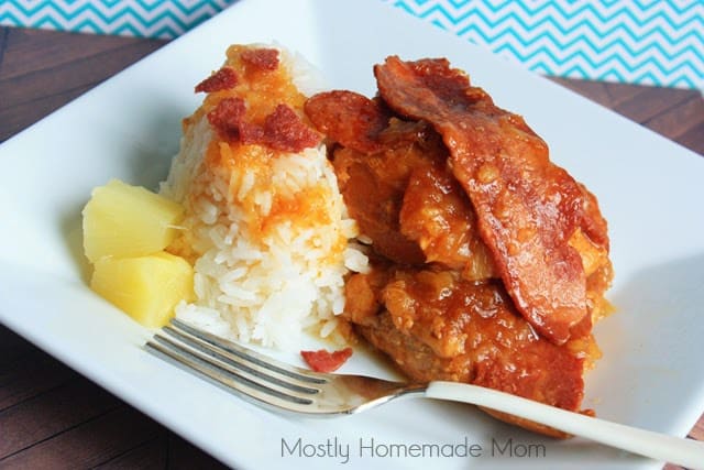 Crockpot hula chicken on a white square plate next to some rice and pineapple