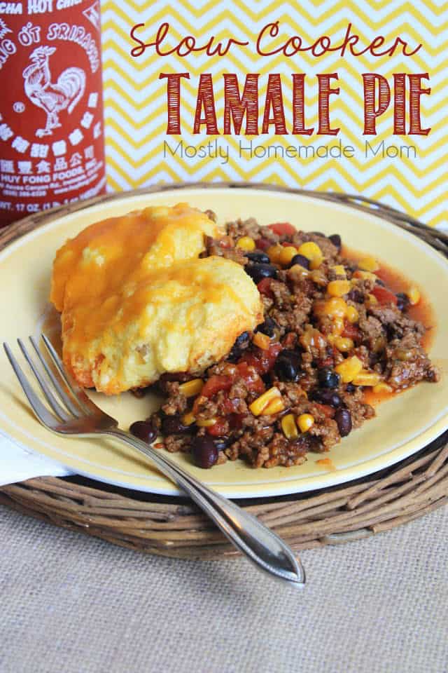 Tamale pie on a plate topped with cornbread and cheese